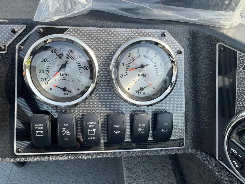 Slide: The Image of Dashboard of 2026 Lund 1650 Rebel XL SS boat with gauges and control switches. - 23