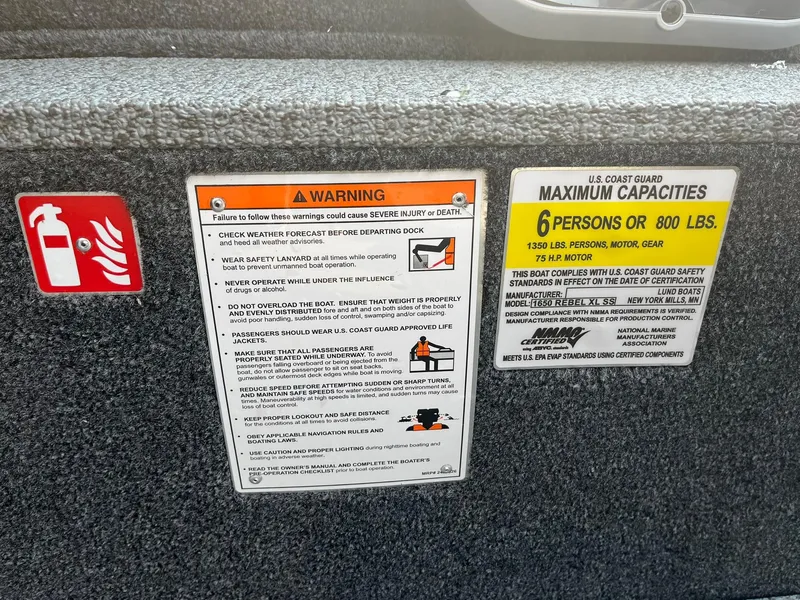 Slide: The Image of Safety and capacity warnings on a 2026 Lund 1650 Rebel XL SS boat. - 24