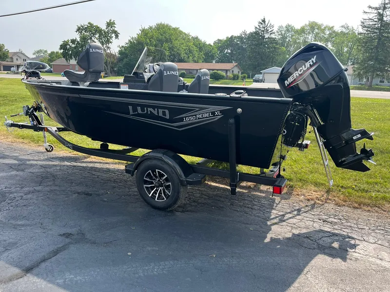 Slide: The Image of 2026 Lund 1650 Rebel XL SS boat with Mercury outboard motor on a trailer. - 3