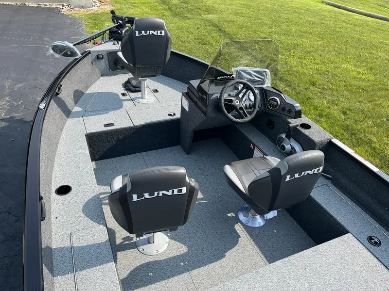 Slide: The Image of 2026 Lund 1650 Rebel XL SS boat interior with steering console and seating. - 6
