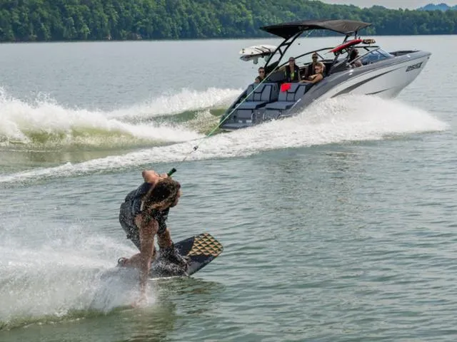 Slide: The Image of Wakeboarder riding behind 2025 Yamaha Boats 255XD on a scenic lake. - 4