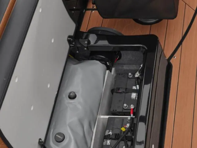 Slide: The Image of Open storage compartment in 2025 Yamaha Boats 255XD, revealing internal components and wiring. - 6