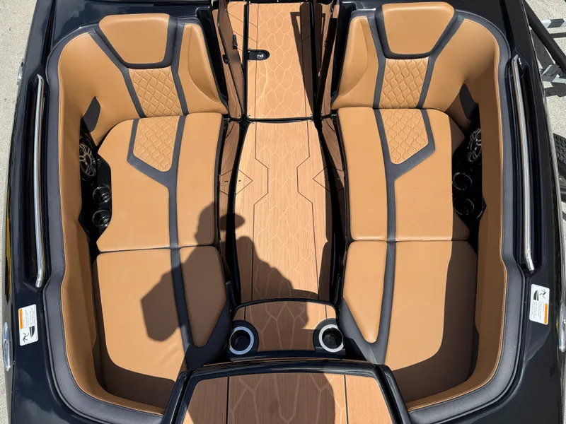 Slide: The Image of 2025 Yamaha Boats 255XD interior with tan and black seating, modern design. - 16