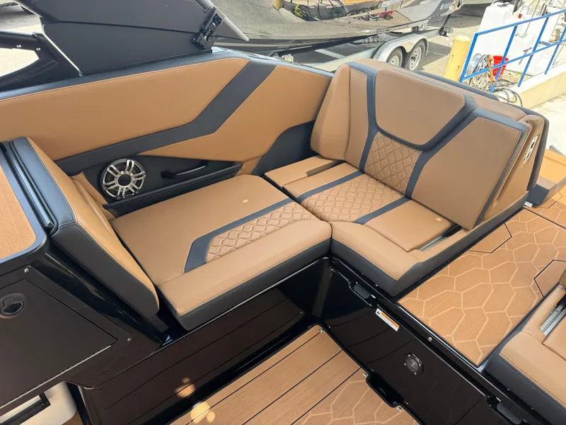 Slide: The Image of Luxurious seating in 2025 Yamaha Boats 255XD, featuring tan upholstery and modern design. - 23