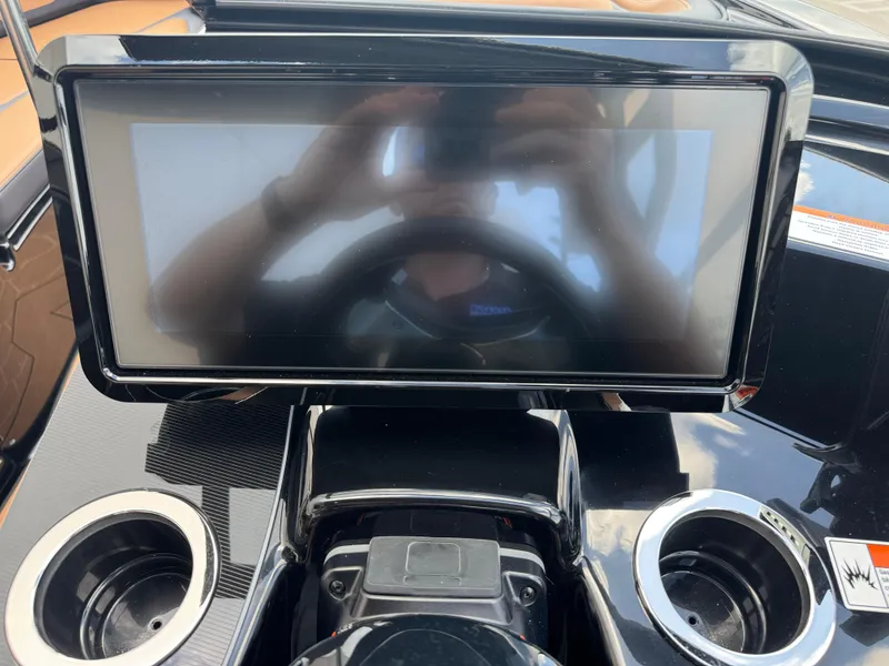 Slide: The Image of Dashboard of 2025 Yamaha Boats 255XD with touchscreen and cup holders. - 31