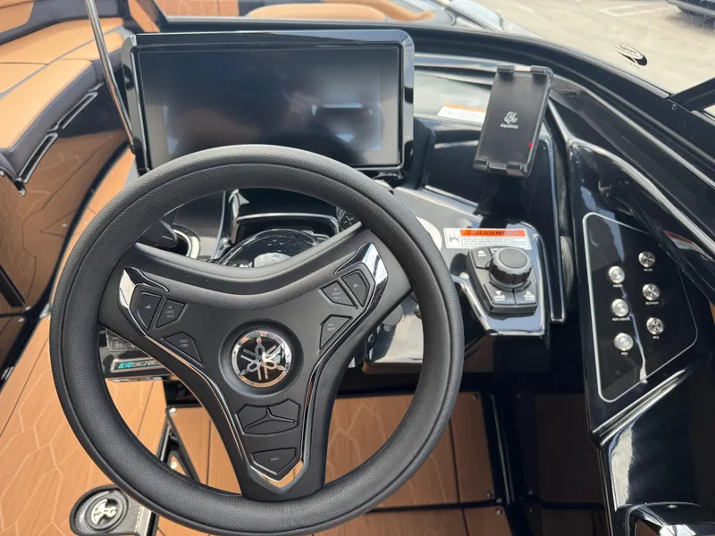 Slide: The Image of 2025 Yamaha Boats 255XD steering wheel and dashboard with modern controls and touchscreen display. - 28