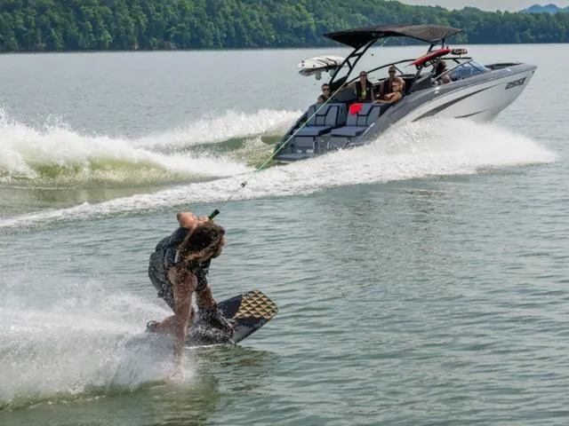 Slide: The Image of Wakeboarder riding behind 2025 Yamaha Boats 255XD on a scenic lake. - 5