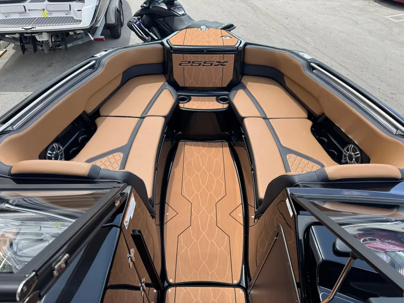 Slide: The Image of 2025 Yamaha Boats 255XD interior with tan seating and sleek design. - 13