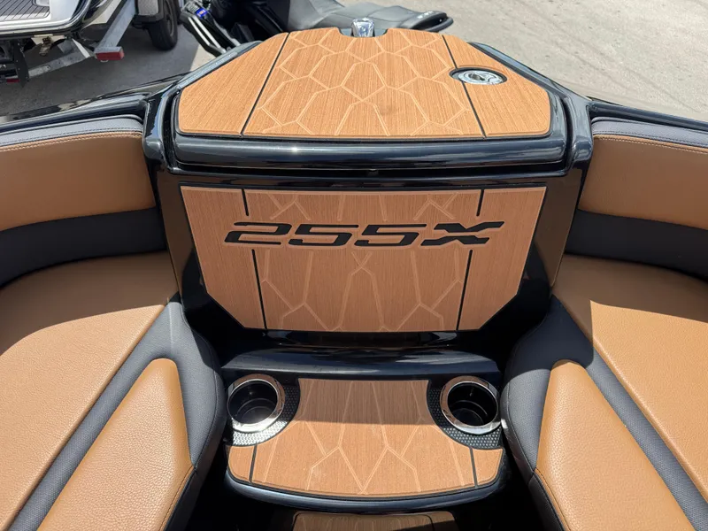 Slide: The Image of 2025 Yamaha Boats 255XD interior with tan seating and cup holders. - 14