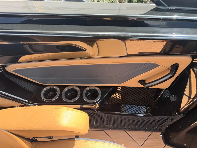 Slide: The Image of Interior of 2025 Yamaha Boats 255XD, featuring sleek design and cup holders. - 19