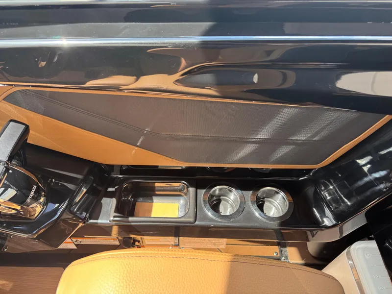 Slide: The Image of Interior of 2025 Yamaha Boats 255XD, featuring sleek design and cup holders. - 26