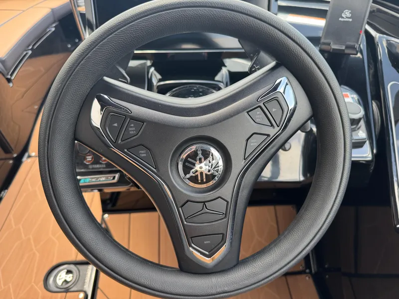 Slide: The Image of Steering wheel of 2025 Yamaha Boats 255XD with control buttons. - 30