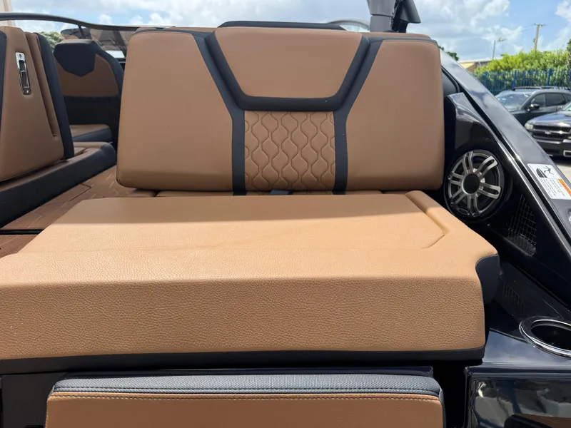 Slide: The Image of 2025 Yamaha Boats 255XD interior with tan leather seating and speaker system. - 4