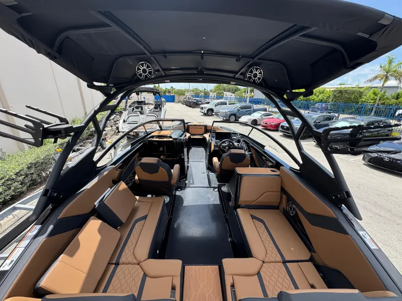 Slide: The Image of 2025 Yamaha Boats 255XD interior with tan seating and modern design features. - 8