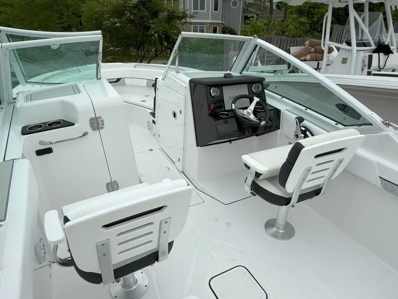 Slide: The Image of 2026 Blackfin 232 DC boat interior with dual console and seating, featuring modern design and controls. - 11