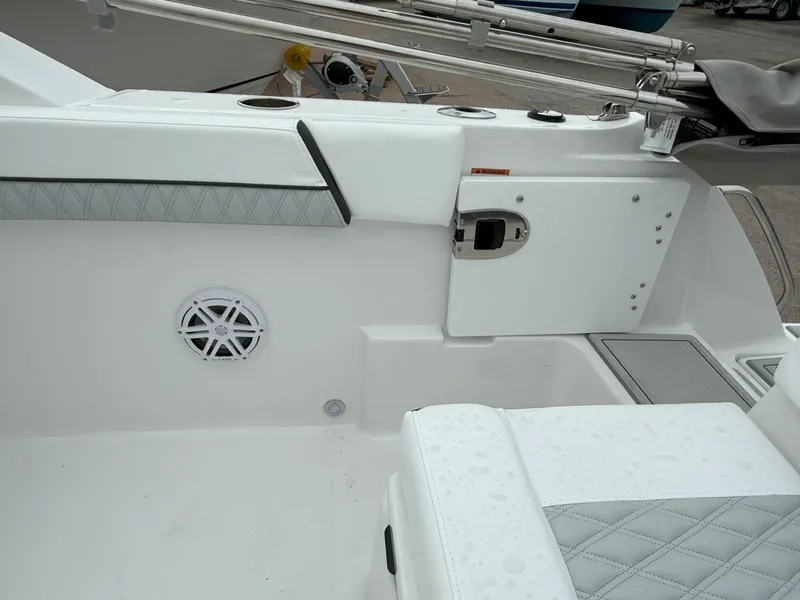 Slide: The Image of 2026 Blackfin 232 DC boat interior with white seating and speaker detail. - 12