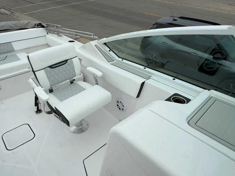 Slide: The Image of 2026 Blackfin 232 DC boat interior with white seating and modern dashboard. - 17