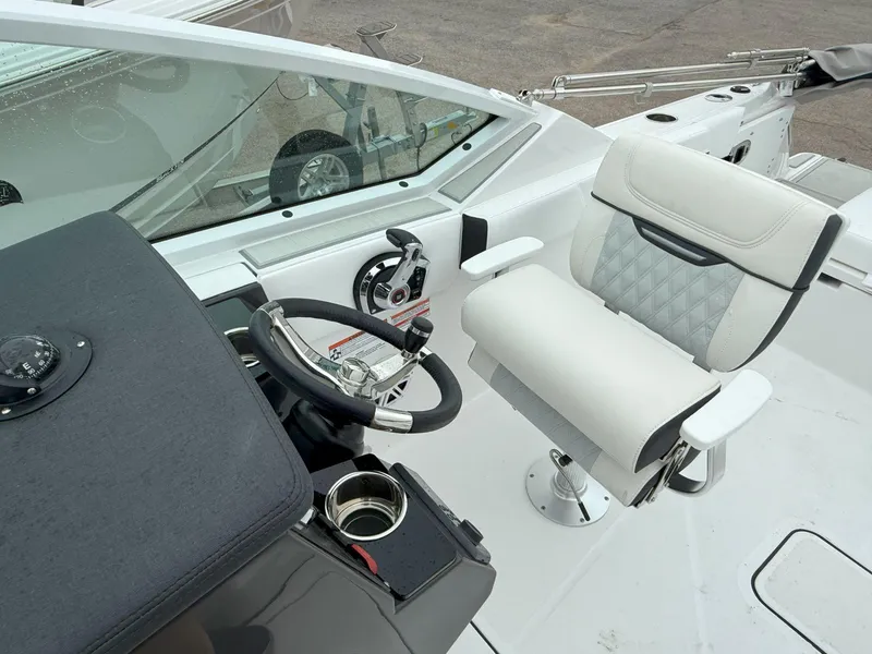Slide: The Image of 2026 Blackfin 232 DC boat cockpit with steering wheel and comfortable seating. - 18