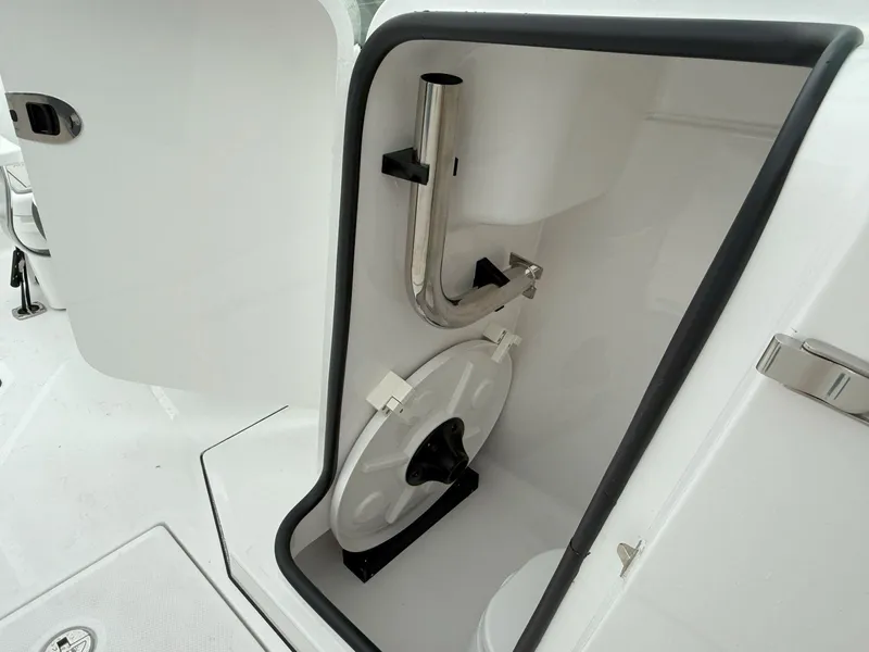 Slide: The Image of 2026 Blackfin 232 DC boat interior storage compartment with stainless steel fixtures. - 22