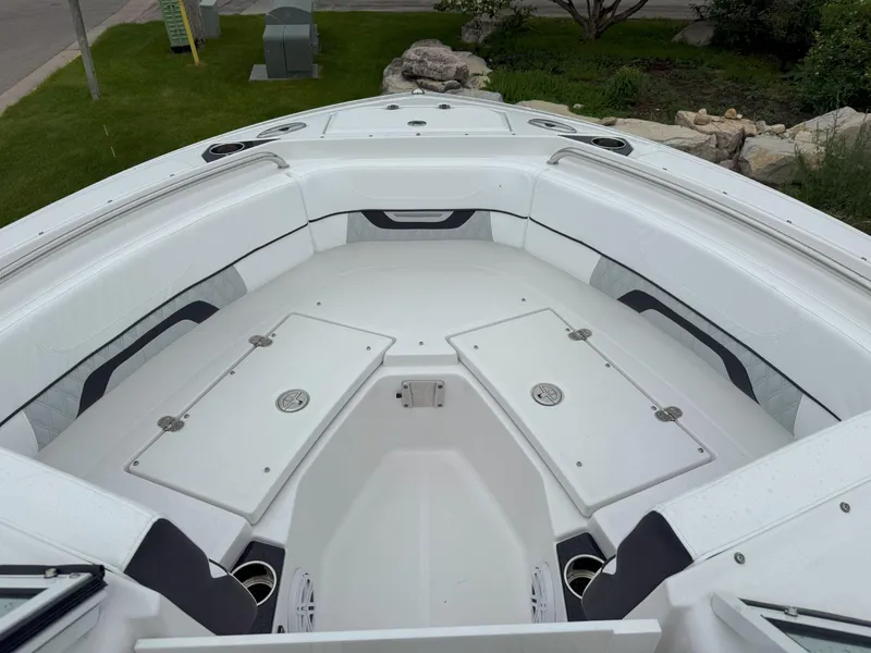 Slide: The Image of 2026 Blackfin 232 DC boat interior with white seating and storage compartments. - 24