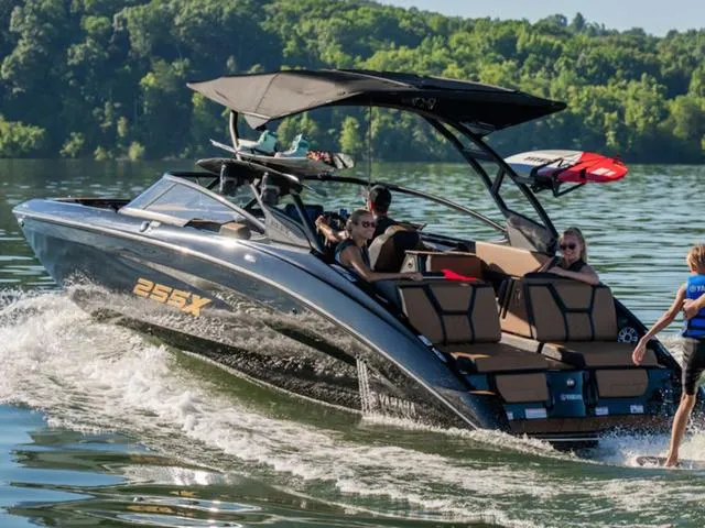 Slide: The Image of 2025 Yamaha Boats 255XD cruising on a lake with passengers enjoying the ride. - 3
