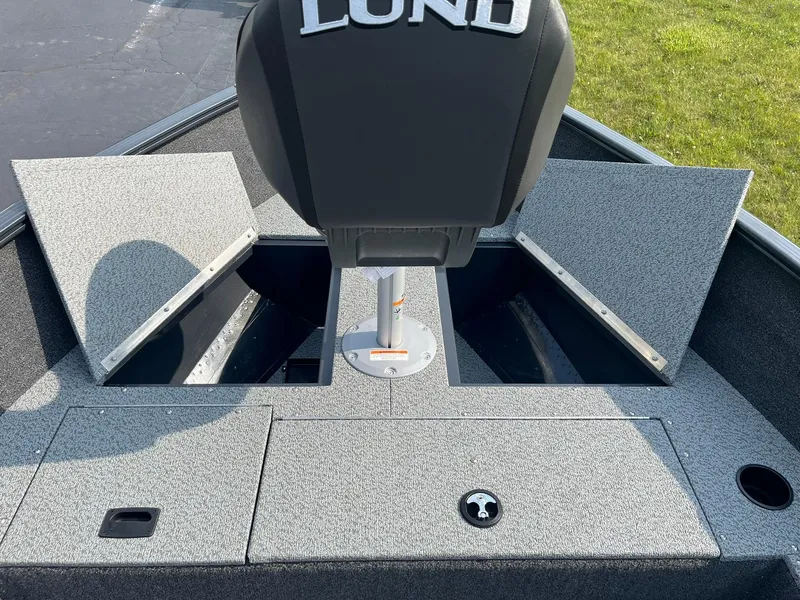 Slide: The Image of 2026 Lund 1650 Rebel XL Tiller boat interior with storage compartments open. - 11