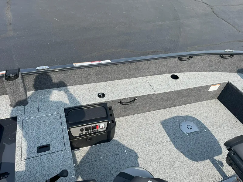 Slide: The Image of 2026 Lund 1650 Rebel XL Tiller boat interior with seating and control panel. - 13