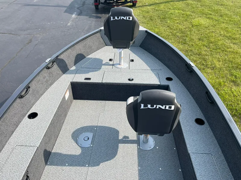 Slide: The Image of 2026 Lund 1650 Rebel XL Tiller boat interior with two seats and spacious deck. - 6