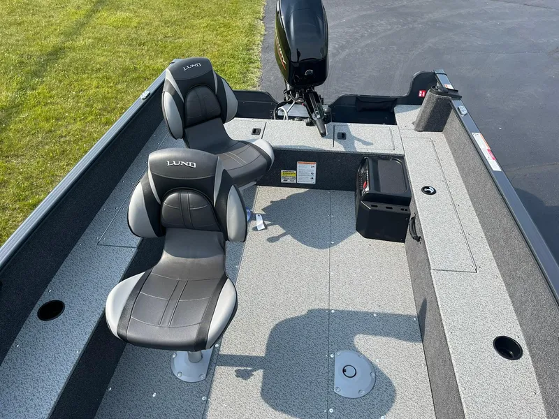 Slide: The Image of 2026 Lund 1650 Rebel XL Tiller boat interior with two seats and motor. - 7
