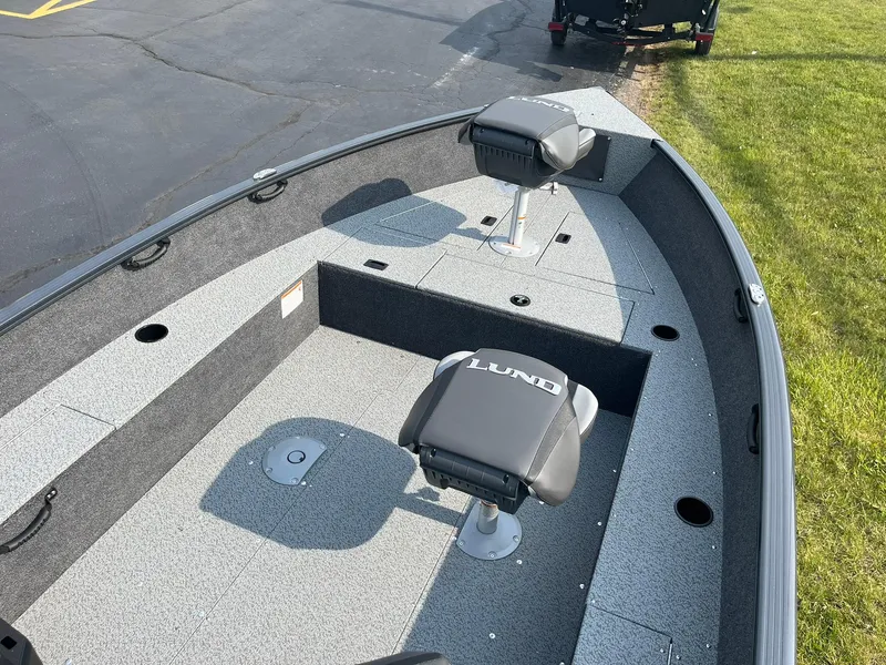 Slide: The Image of 2026 Lund 1650 Rebel XL Tiller boat interior with seating and storage compartments. - 9