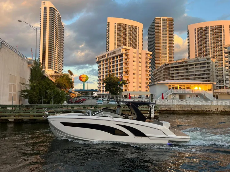 The Image of Modern Hanover 377 boat cruising near urban high-rise buildings at sunset, 2023 model. - 0