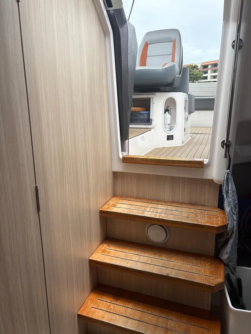 Slide: The Image of Interior view of 2023 Hanover 377 boat, featuring wooden steps leading to the deck. - 15