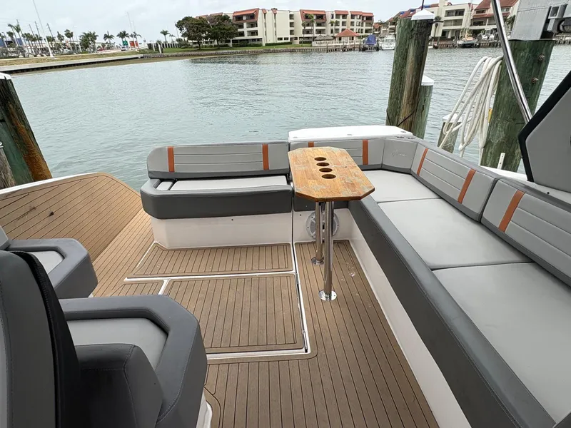 Slide: The Image of Luxurious 2023 Hanover 377 yacht deck with elegant seating and wooden table by the marina. - 17