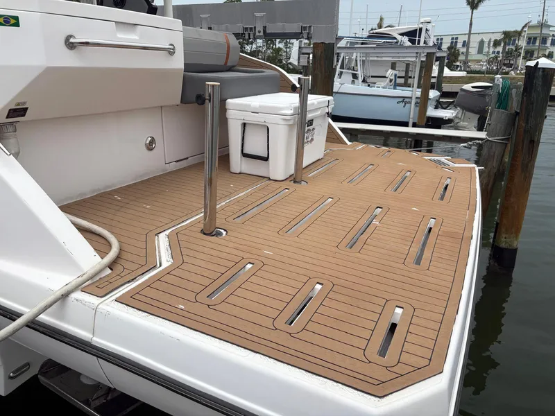 Slide: The Image of 2023 Hanover 377 boat deck with teak flooring at a marina. - 21