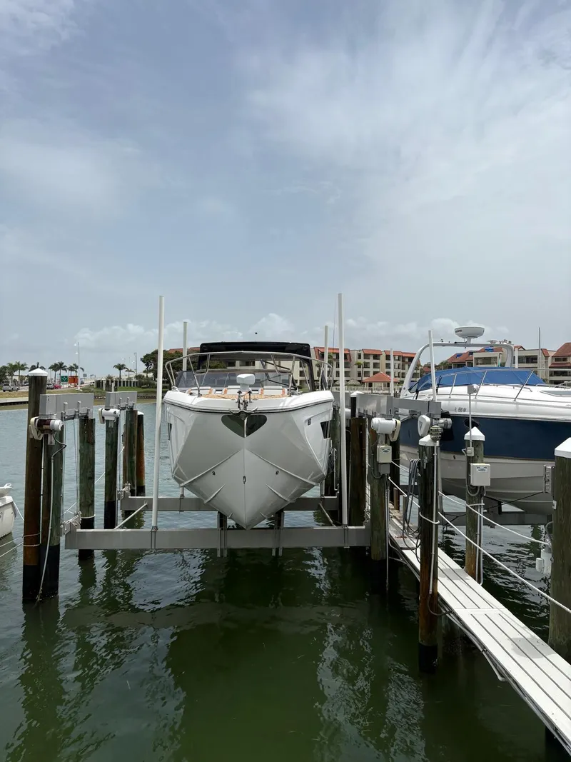 Slide: The Image of 2023 Hanover 377 boat docked at marina under cloudy sky. - 23