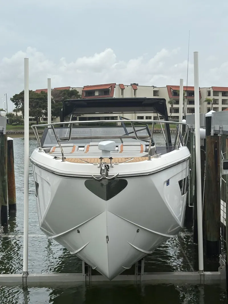 Slide: The Image of 2023 Hanover 377 boat docked at marina, front view with modern design. - 24