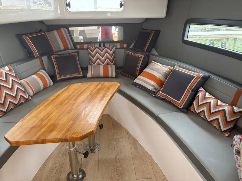 Slide: The Image of Luxurious Hanover 377 yacht interior with stylish cushions and wooden table, 2023 model. - 7