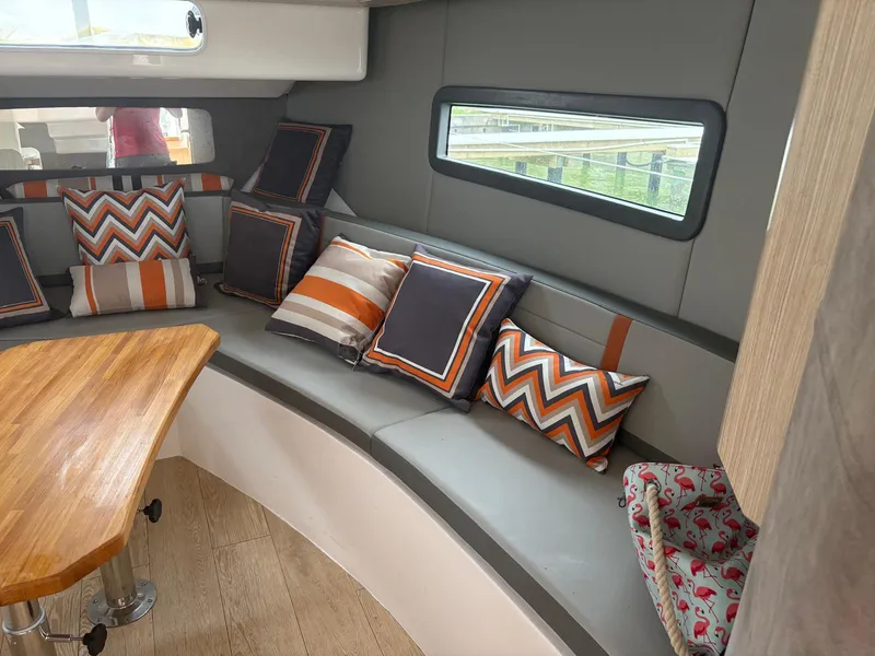 Slide: The Image of Luxurious Hanover 377 yacht interior with stylish cushions and wooden table, 2023 model. - 8