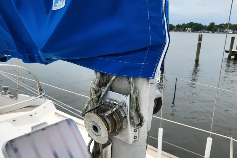 Slide: The Image of Close-up of a 1974 Hallberg-Rassy Rasmus 35 sailboat mast with blue sail cover. - 12