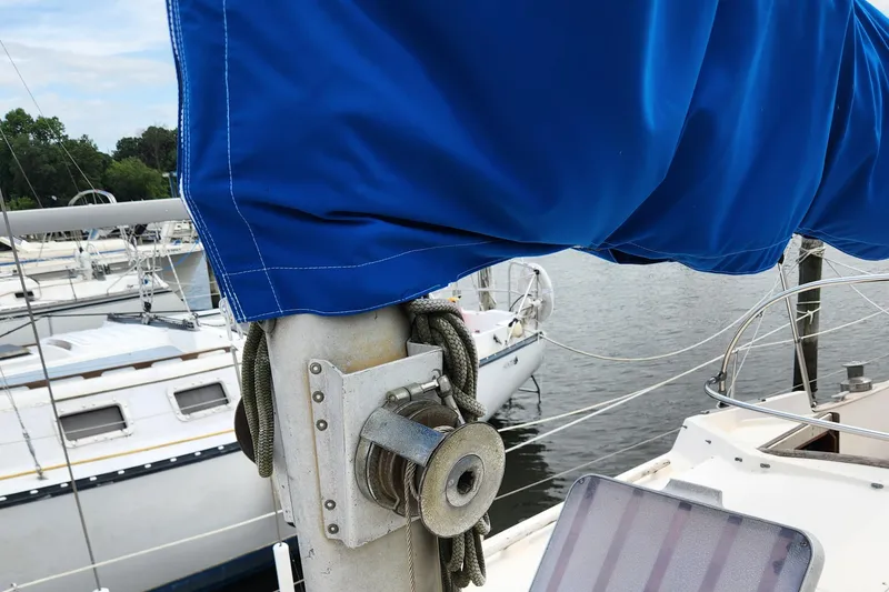 Slide: The Image of Close-up of a 1974 Hallberg-Rassy Rasmus 35 sailboat mast with blue sail cover. - 13