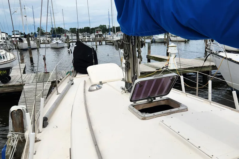 Slide: The Image of 1974 Hallberg-Rassy Rasmus 35 sailboat docked at a marina, open hatch on deck. - 15