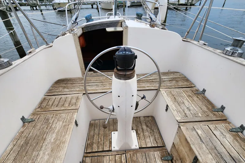 Slide: The Image of Cockpit of 1974 Hallberg-Rassy Rasmus 35 sailboat with wooden seating and steering wheel. - 22