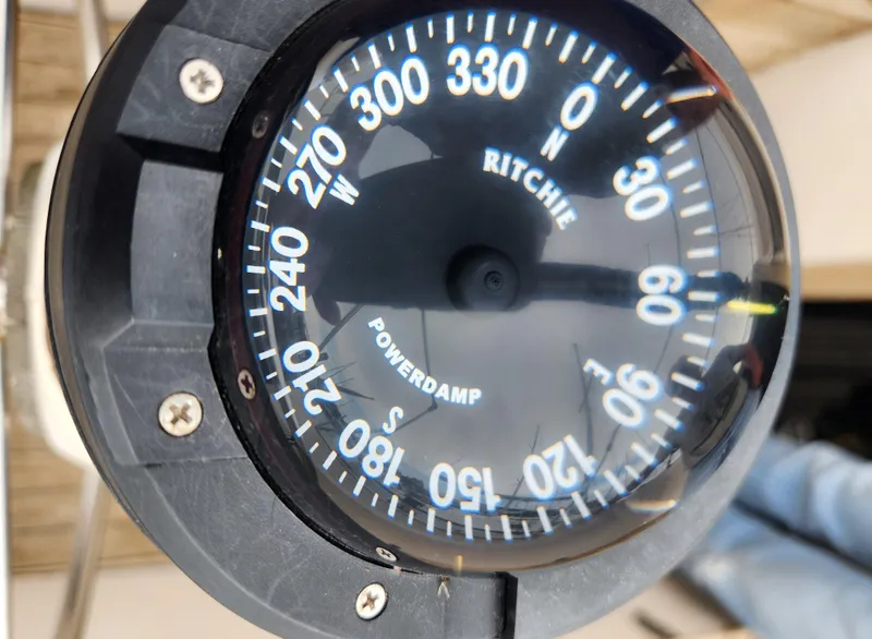 Slide: The Image of Compass on 1974 Hallberg-Rassy Rasmus 35 sailboat, displaying cardinal directions. - 24