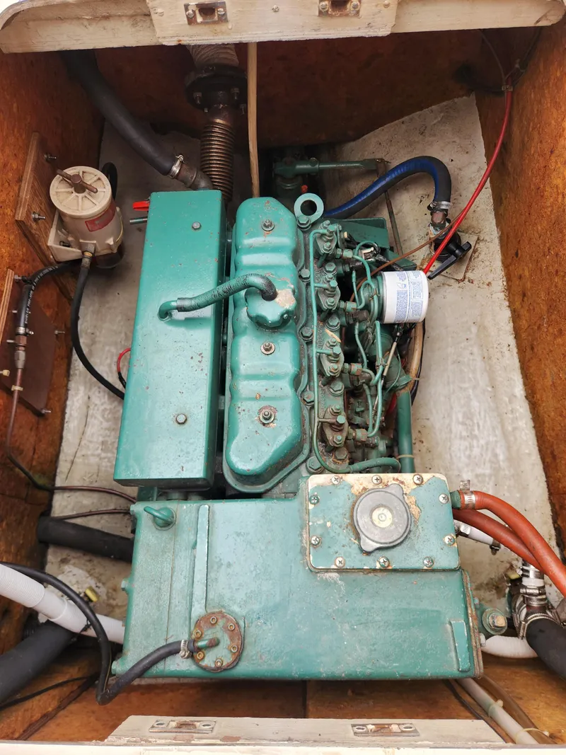 Slide: The Image of Engine compartment of a 1974 Hallberg-Rassy Rasmus 35 sailboat, showcasing a vintage marine engine. - 32