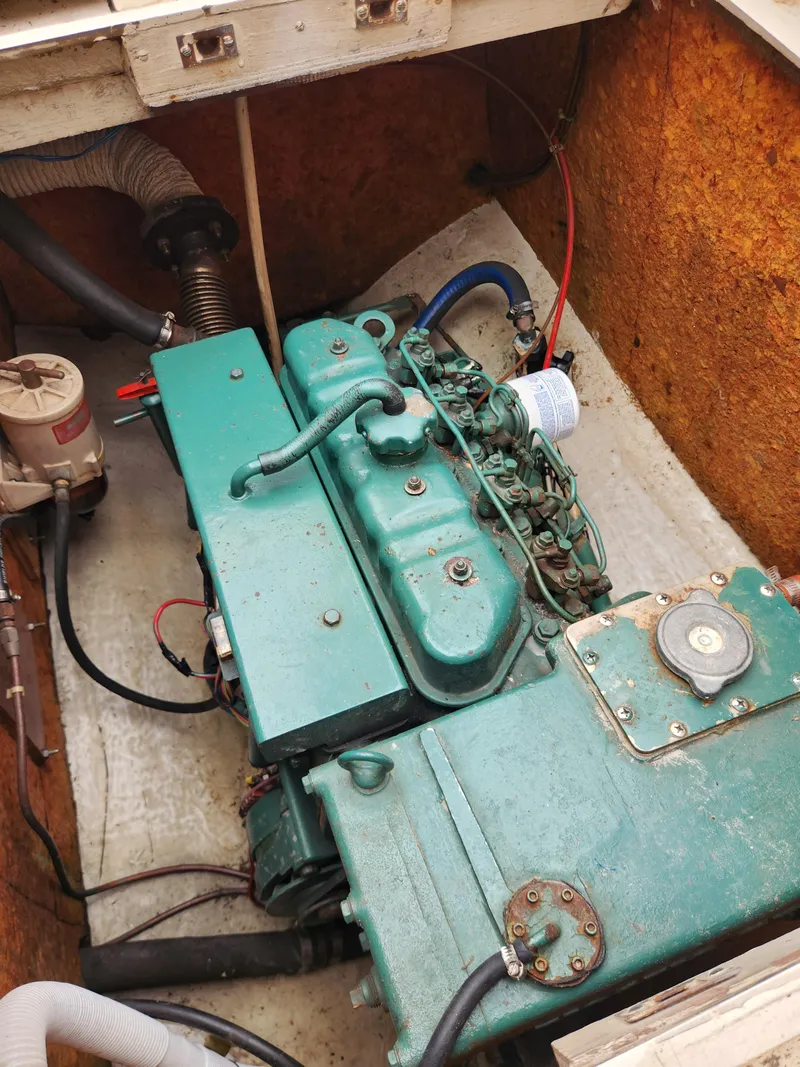 Slide: The Image of Engine compartment of a 1974 Hallberg-Rassy Rasmus 35 sailboat, featuring a green marine engine. - 33