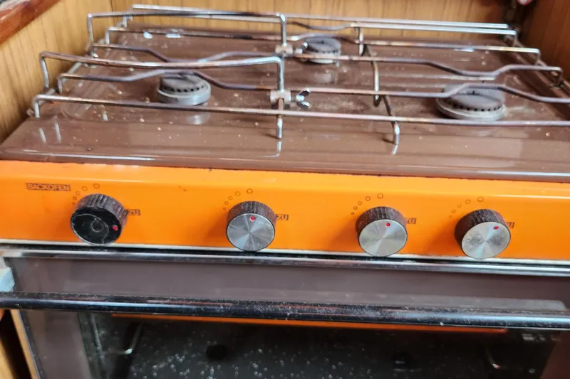 Slide: The Image of Vintage stove with orange control panel on a 1974 Hallberg-Rassy Rasmus 35 yacht. - 39