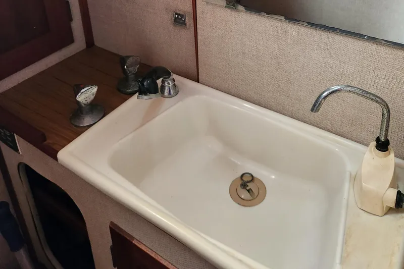 Slide: The Image of 1974 Hallberg-Rassy Rasmus 35 yacht sink with faucet and countertop. - 45