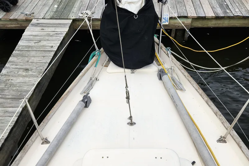 Slide: The Image of 1974 Hallberg-Rassy Rasmus 35 sailboat docked, showing deck and rigging details. - 5