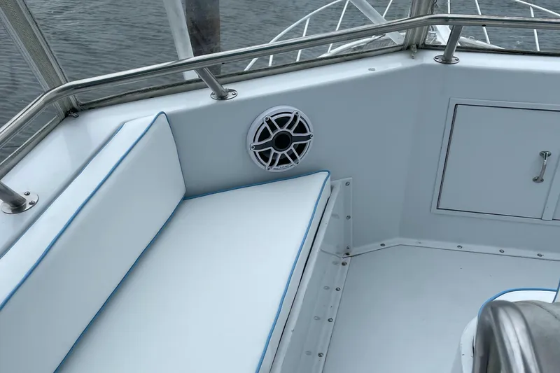 Slide: The Image of Interior view of a 1990 Hatteras 45 Convertible boat with cushioned seating and speaker. - 26