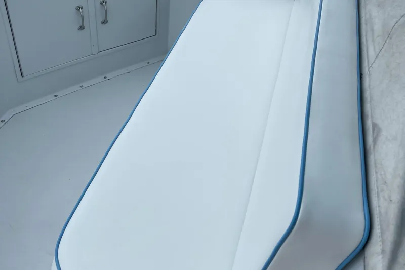 Slide: The Image of White cushioned seating on 1990 Hatteras 45 Convertible boat with blue trim. - 24